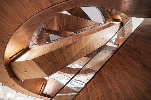 Image 2: A look up reveals all the beauty of europlac's walnut veneer. Author credit: Photograph by Marco Cappelletti, Courtesy of OMA